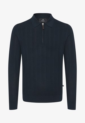 Ciemnoniebieski sweter z dzianiny z kołnierzykiem i ćwierć zamkiem. Posiada prążkowaną fakturę i długie rękawy.