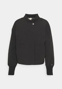Black cropped jacket with a high collar, snap closure, two front pockets, elastic cuffs, and a small logo detail on the sleeve.