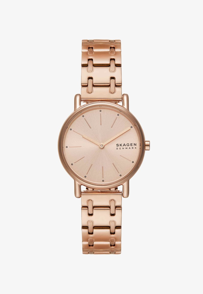 Montre-bracelet Skagen en or rose avec un cadran circulaire minimaliste, index des heures en bâtons, deux aiguilles et un bracelet en maillons métalliques.