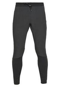 Pantalones deportivos negros de tela ligera, con una cinturilla elástica ajustable, corte entallado y sutiles detalles de panel contrastante.