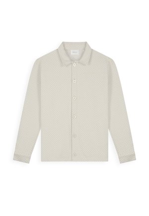 Light beige button-up shirt with long sleeves, subtle textured pattern, and classic collar. Features six buttons along the front.