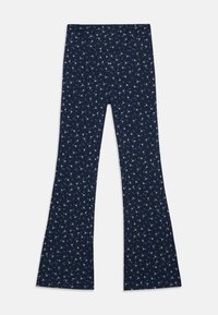 Leggings évasés bleu marine en tissu doux, ornés d'un petit motif floral avec des fleurs blanches et vertes.