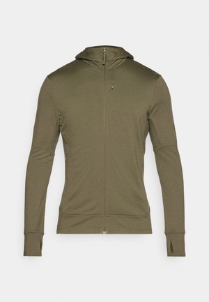 Long-sleeved, olive green zip-up hoodie made from a soft fabric; features a fitted hood and thumbholes at the sleeve cuffs.