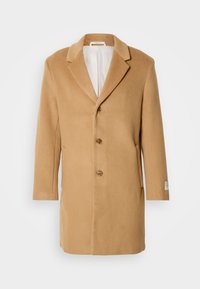 Κωδικός καφέ μάλλινο παλτό με γιακά με αυλακώσεις, μονό γαζί, τρία κουμπιά και πλαϊνές τσέπες. Λείος υφασμάτινος σχεδιασμός με μεσαίο μήκος.