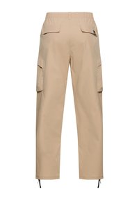 Beige cargo pants with elastic waistband, rear flap pockets, side cargo pockets, and adjustable drawstrings at the ankle hems.