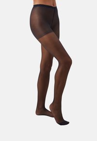 Collants noirs transparents avec une taille festonnée et une texture lisse, dotés d'une zone de orteils renforcée pour une durabilité accrue.
