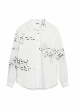 Valge pikamäe särk, millel on müüriks musta käekirja sarnane tekst ja abstraktsed mustrid. Esikäel nööbitav, ümar äär ja mansetiga varrukad.