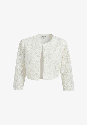 Veste courte en dentelle blanche avec manches longues, encolure ronde et devant ouvert, présentant un motif floral en dentelle délicat sur toute la surface.