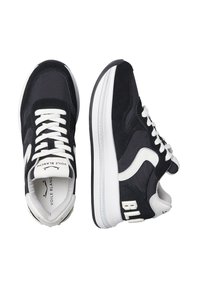 Sneaker bianco e nero caratterizzati da un mix di materiali in suede e tessuto, un design elegante, lacci bianchi spessi e dettagli del logo audaci.