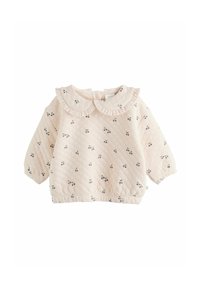 Blusa per neonati in rosa pallido trapuntata, con maniche lunghe, colletto Peter Pan arricciato, orlo elastico e piccolo motivo a ciliegie su tutta la superficie.