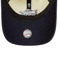 New Era baseball cap, navy fabric, curved brim, embroidered logo inside, circular sticker with baseball graphic on the underside.