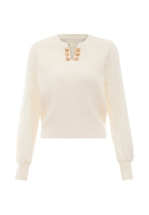 Strickpullover in Creme mit gerippter Textur, puffartigen Spitzenärmeln und goldenen Hardware-Knöpfen am Hals, cropped Länge.