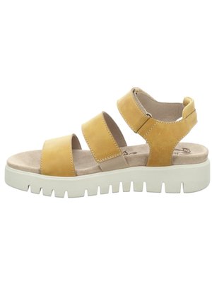 Yellow leather sandal with three wide straps, a cushioned footbed, and a thick white rubber sole featuring a textured grip pattern.