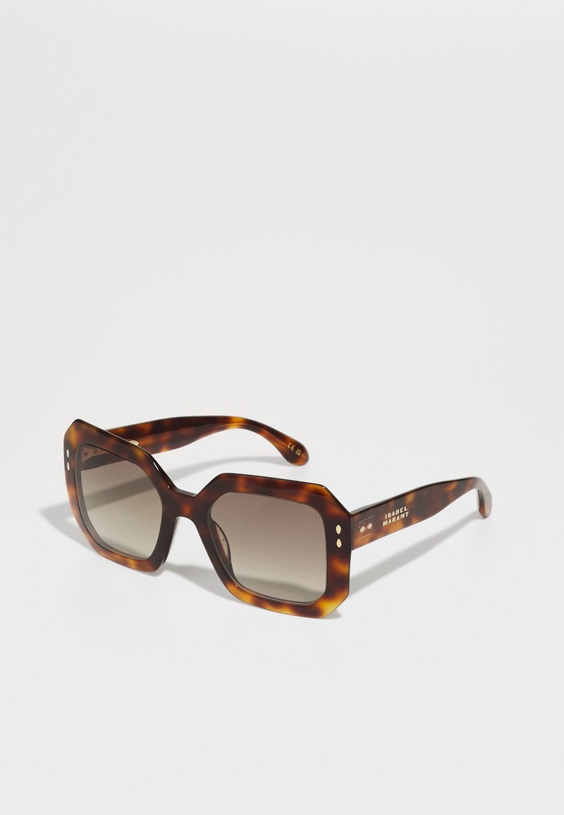 Tortoiseshell sunglasses with a bold octagonal frame and gradient lenses. Features small decorative accents on the temples.