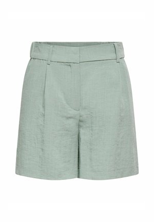 Short en lin vert clair à taille haute avec passants de ceinture, pli sur le devant et fermeture dissimulée sur le devant.