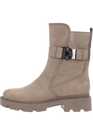 Taupe suede ankle boot with a rounded toe, chunky rubber sole, and a decorative buckle strap on the side. Stitching details visible.