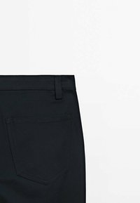 Black trousers featuring a smooth fabric texture, a straight-cut design, and a single back pocket with subtle stitching detail.