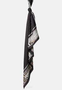 Foulard in seta bianco e nero con motivi geometrici, caratterizzato da strisce e dettagli a catena. Morbido al tatto, annodata nella parte superiore.