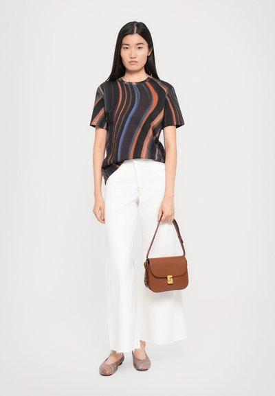 Black top with colorful wavy stripes, white wide-leg pants, brown handbag with gold clasp, and multi-colored striped flats.