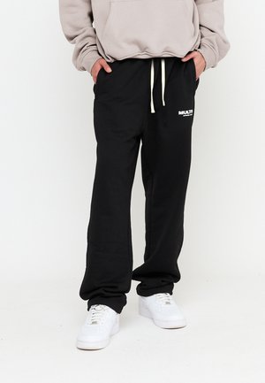CLUB - Tracksuit bottoms - black