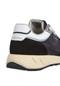 Black and navy sneaker with suede and textile materials, white accents, and a cream rubber sole. Features "DENIM BRAND" embossed on the heel.