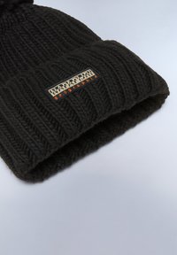 Black knitted beanie with a ribbed design. Features a fold-over cuff and a rectangular logo tag in cream and orange. Soft texture.