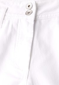 Pantalones de mezcla de algodón blancos que presentan un cierre de cremallera, dos botones metálicos y detalles de costura sutiles a lo largo de las costuras.