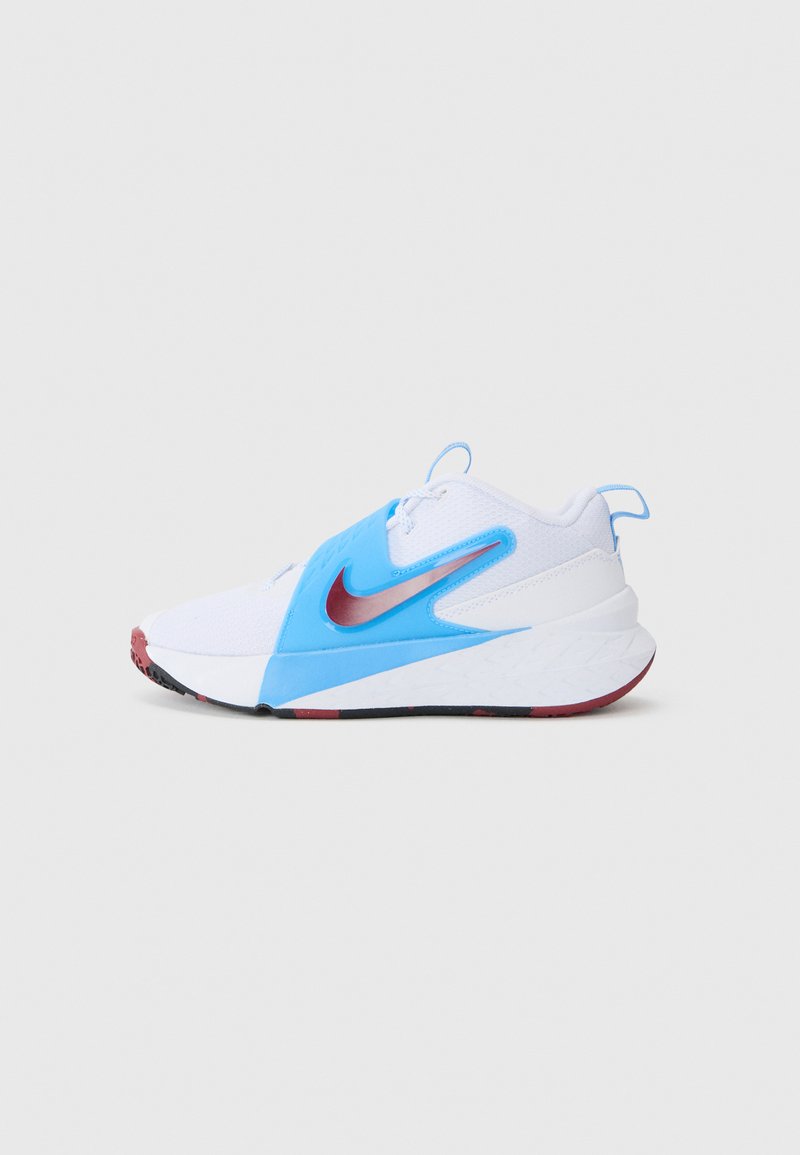Nike athletic shoe featuring a white mesh upper, blue synthetic accents, a red swoosh logo, and a textured black and red sole.