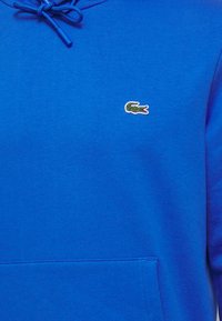 Lacoste Jersey con capucha - ladigue