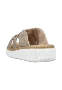 Beige slip-on sandal with textured fabric upper, open design, cushioned insole, and white ribbed sole featuring a logo accent.