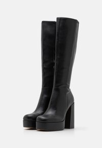 Black high-heeled boots made of smooth leather with a rounded toe, tall shaft, and chunky block heel. Features a side zipper for closure.