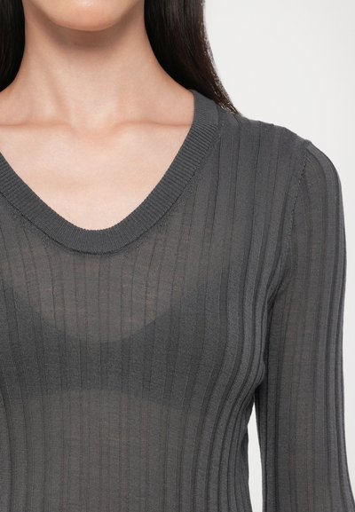 Grey ribbed knit top with a V-neckline, long sleeves, and a sheer texture, highlighting vertical lines and a fitted silhouette.