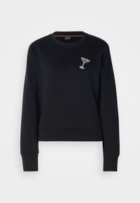 Sudadera negra con cuello redondo y mangas largas. Presenta una copa de cóctel decorada con cristales en el pecho izquierdo. Tejido suave.