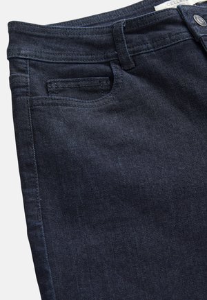 Dark blue denim jeans with a smooth texture, featuring a standard waistband, small front pocket, and minimal stitching details.