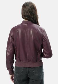 Burgunderfarbene Lederbomberjacke mit gerippten Bündchen und Saum. Verfügt über eine Seiten pocket am Ärmel und eine glatte, glänzende Textur.