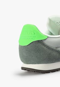 Grau und grüne Sneaker mit einem Wildleder-Fersenbereich, strukturiertem grauen Material, weißen Nähten und einer strukturierten schwarzen Gummisohle.