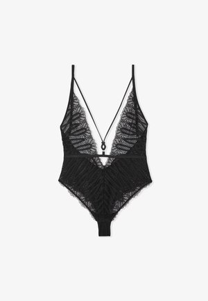 Bodysuit en dentelle noire avec des motifs en vagues complexes, décolleté en V profond, bretelles réglables et design dos thong. Texture douce et légère.