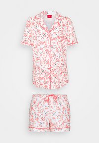 Short-sleeve floral pajama set with pink accents and a pocket; features a loose-fitting top and matching drawstring shorts. White background.
