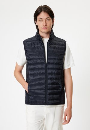Navy quilted vest with a high collar, front zip closure, and side pockets. Lightweight, smooth texture with horizontal stitching details.