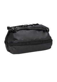 Black duffel bag made of durable, smooth material. Features adjustable straps, a zippered opening, and looped handles for carrying.