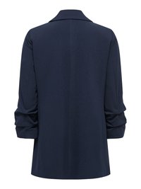 Blazer bleu marine à manches longues avec manches froncées, vu de dos sur un fond blanc uni.