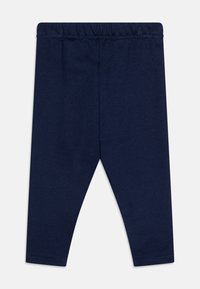 Marinblå tights laget av mykt stoff med elastisk midjebånd, med en tettsittende design og uten synlige mønstre eller detaljer.