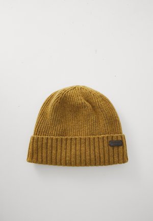 Mustard yellow ribbed knit beanie with folded cuff and small black Barbour England label on white background.