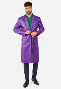 Purple leather coat with a croc texture, featuring a notched lapel, two pockets, and buttons at the front, worn over a green shirt.
