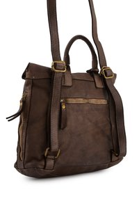 Brown leather backpack with dual top handles and adjustable straps. Features a front zipper pocket and stitching accents.