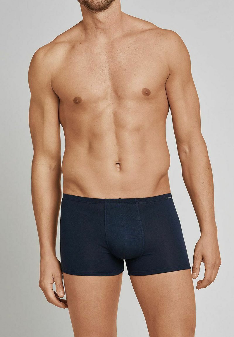 Dark navy fitted boxer shorts made from stretch fabric, featuring a smooth texture, elastic waistband, and a snug design.
