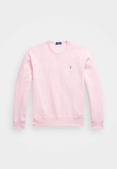 Lyserød sweatshirt lavet af bomuld, med rund halsudskæring, lange ærmer og et lille blåt logo på venstre bryst.