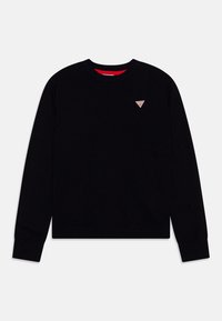 Pull en tricot noir avec un col rond, des poignets et un ourlet côtelés, présentant un petit logo triangulaire sur la poitrine et un col intérieur rouge.