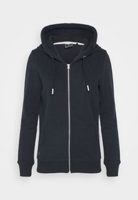 Sort zip-up hoodie med en snoretrækshætte, to forlommer, ribbede manchetter og et lille broderet logo på brystet. Blødt stof.