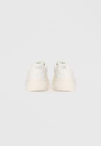 Pair of white Jack & Jones sneakers shown from the back on a plain white background.